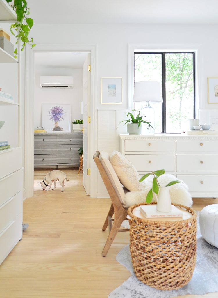 Before photo of bedroom as seen from kitchen with random dressers