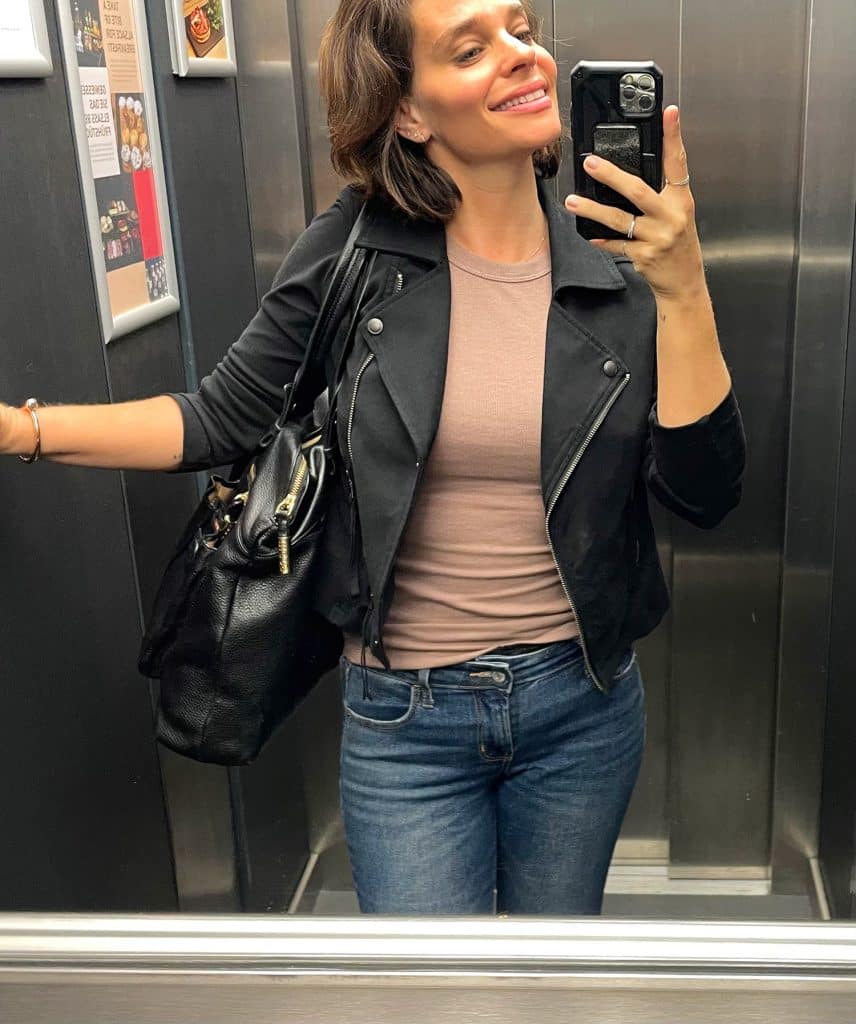 Sherry selfie in elevator with tan tank top and black leather jacket and jeans