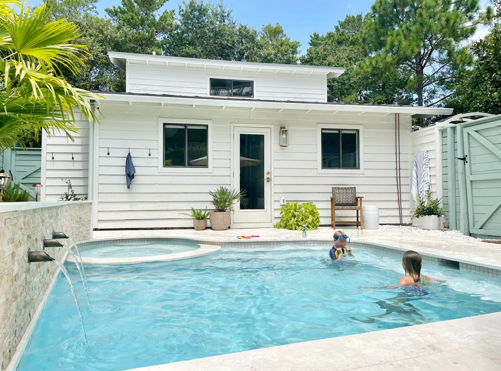 After photo of children playing in small freeform Florida pool with small white house in the background