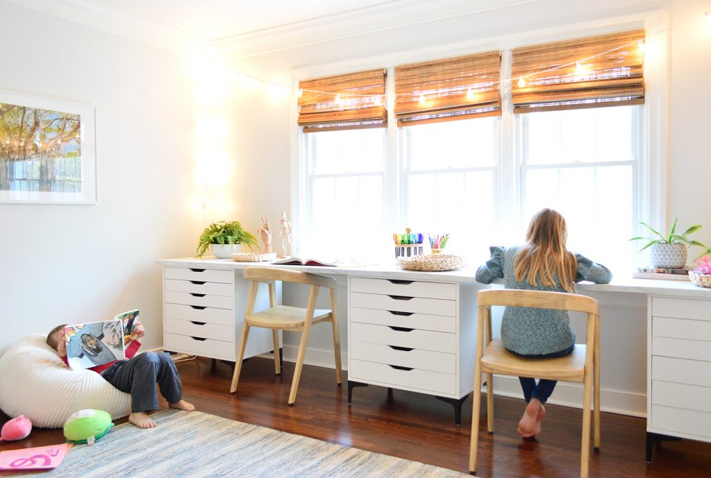 Kids Enjoying Art Room With Long Desk Workspace In Front Of Window And Bean Bag For Reading